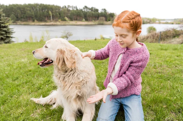 Child playing with dog — Stock Photo