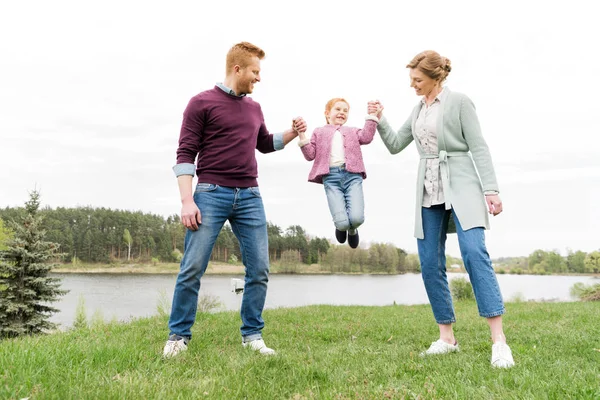 Happy family holding hands — Stock Photo