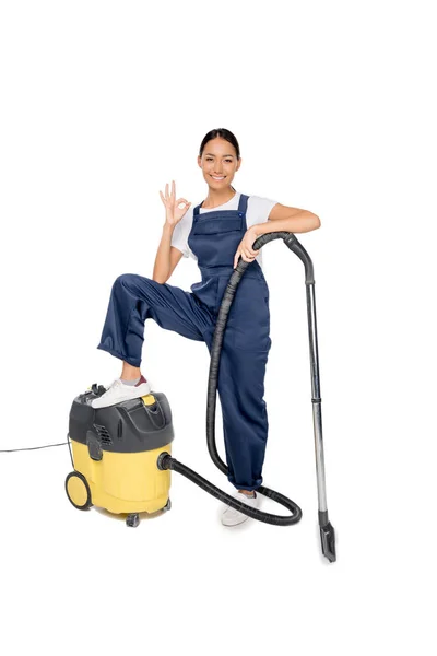 Asian cleaner with vacuum cleaner — Stock Photo