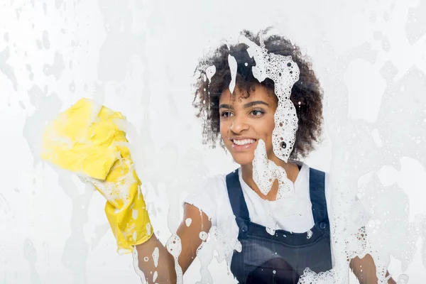 African american cleaner cleaning window — Stock Photo