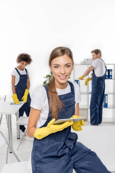 Young cleaner with digital tablet — Stock Photo