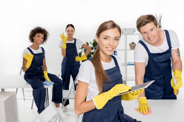 Young cleaner with digital tablet — Stock Photo