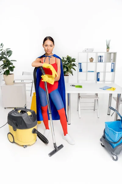 Superhero with vacuum cleaner — Stock Photo