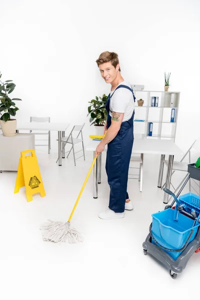 Handsome cleaner washing floor — Stock Photo