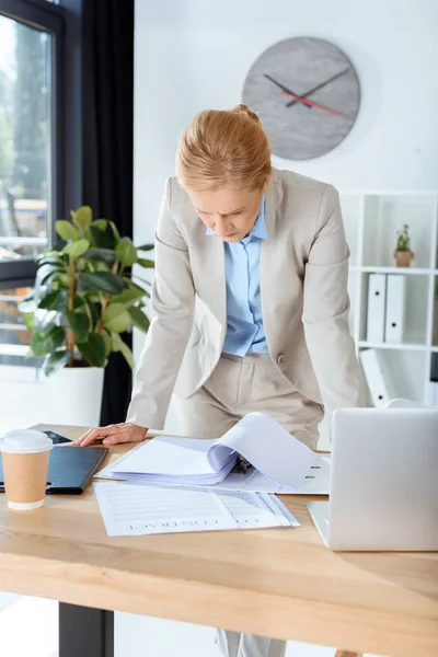 Businesswoman with lot of paperwork — Stock Photo