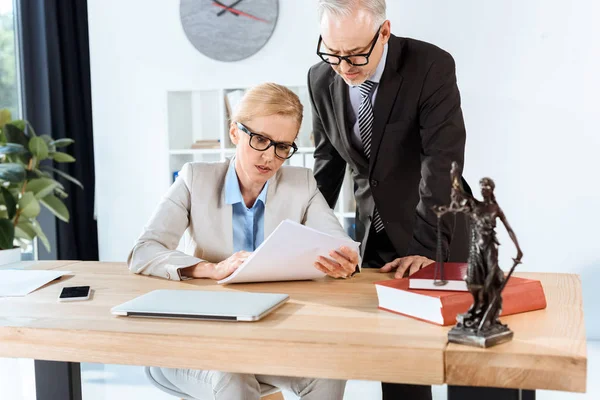 Mature lawyers with paperwork — Stock Photo