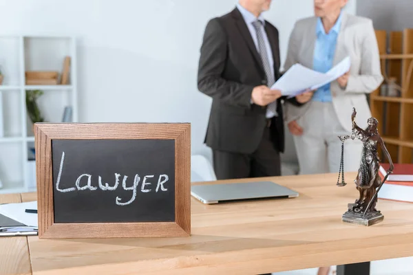 Lawyer workplace with themis sculpture — Stock Photo