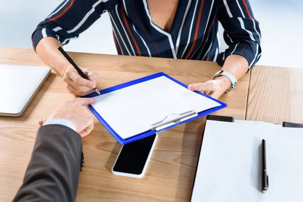 Business partners writing contract — Stock Photo