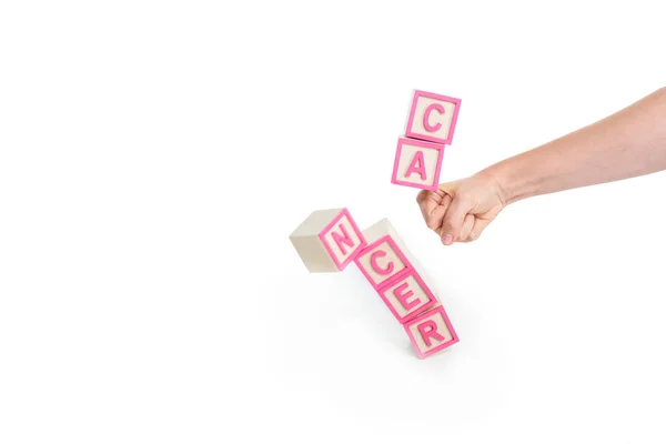 Fist breaking cubes with word cancer — Stock Photo