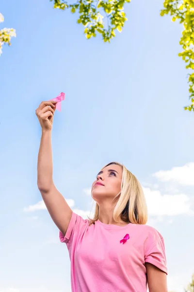 Jeune femme avec ruban rose — Photo de stock