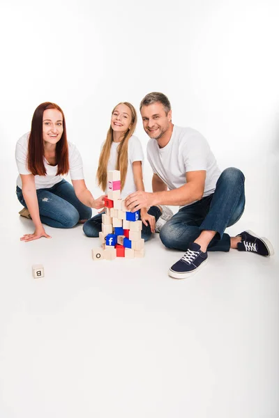 Family playing with alphabet cubes — Stock Photo