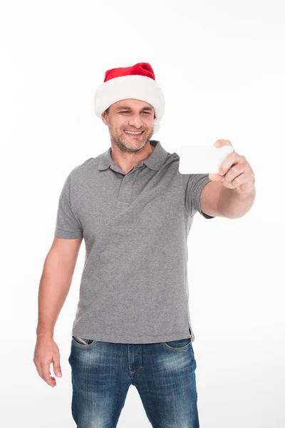 Людина в капелюсі Санта приймає селфі — стокове фото