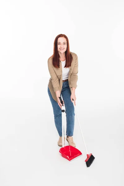 Woman sweeping with broom — Stock Photo