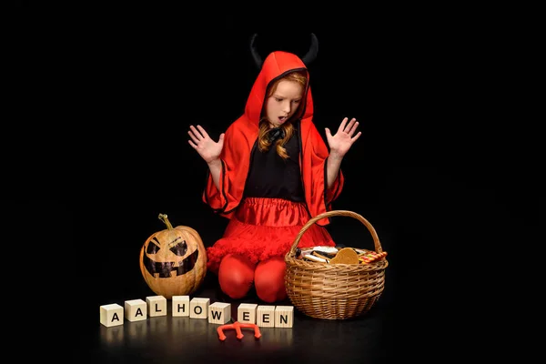 Shocked child in costume of devil — Stock Photo