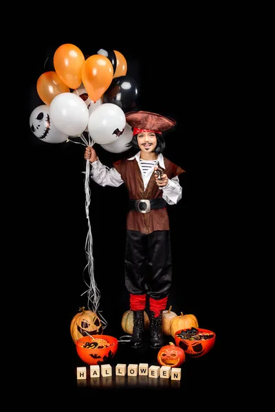 Pirate with balloons, pumpkins and sweets — Stock Photo