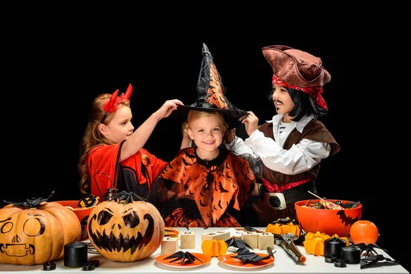 Children in halloween costumes with sweets — Stock Photo