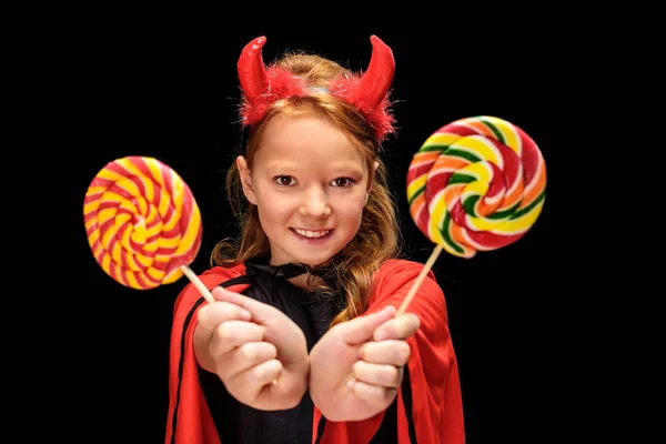Little devil with lollipops — Stock Photo