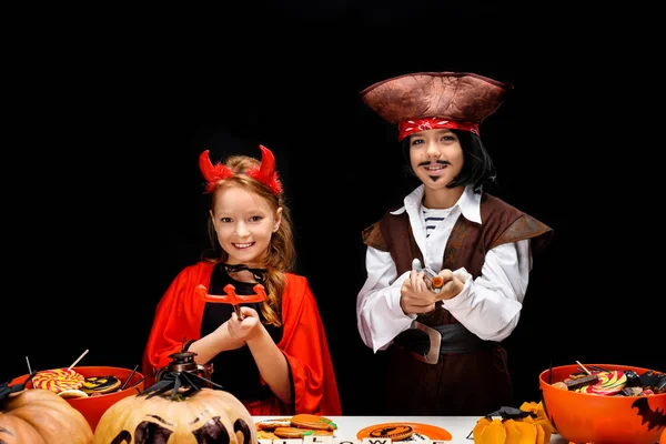 Children in halloween costumes of devil and pirate — Stock Photo