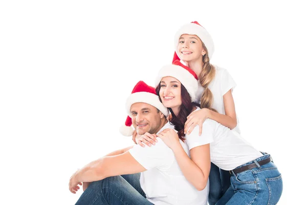 Familie in Weihnachtsmützen umarmen — Stockfoto