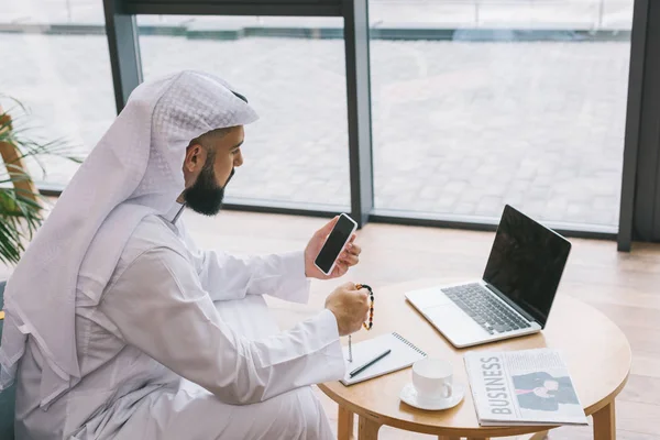 Musulmán hombre de negocios usando teléfono inteligente - foto de stock