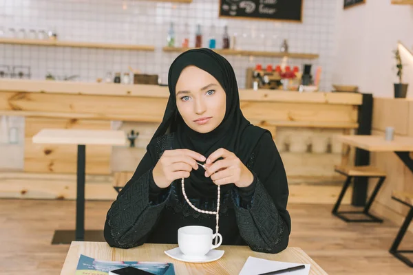 Muslim woman sitting in cafe — Stock Photo