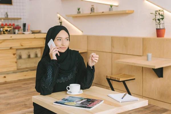 Muslim woman talking by phone — Stock Photo