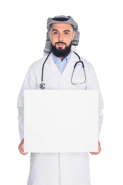 Muslim doctor holding blank board — Stock Photo