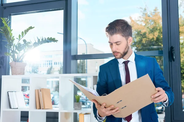 Businessman holding folder — Stock Photo