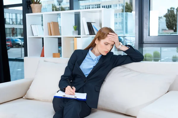 Bouleversé femme d'affaires avec presse-papiers — Photo de stock