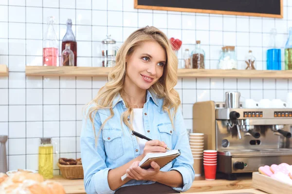 Cafe owner taking notes — Stock Photo