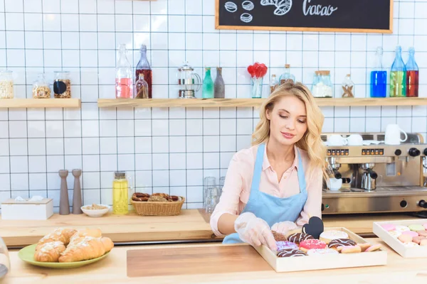 Waitress with donuts — Stock Photo