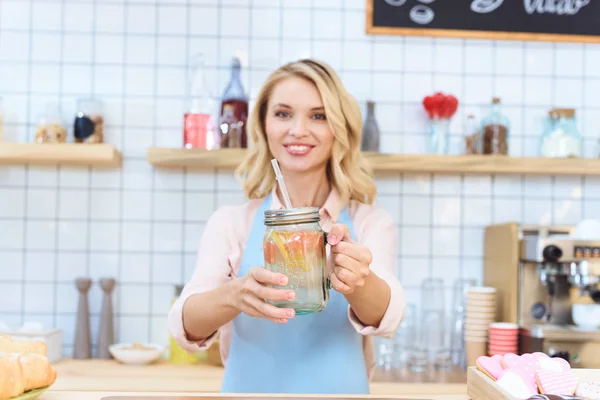 Waitress holding jar with lemonade — Stock Photo