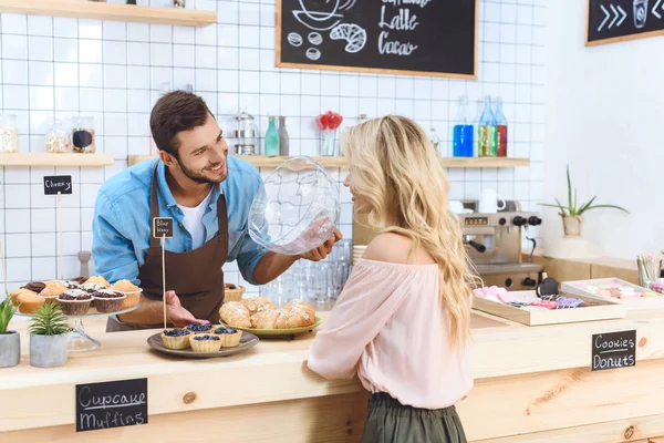 Waiter showing cookies to client — Stock Photo