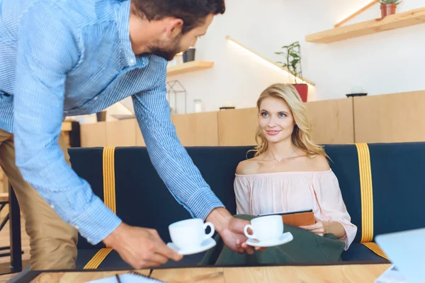 Couple drinking coffee in cafe — Stock Photo