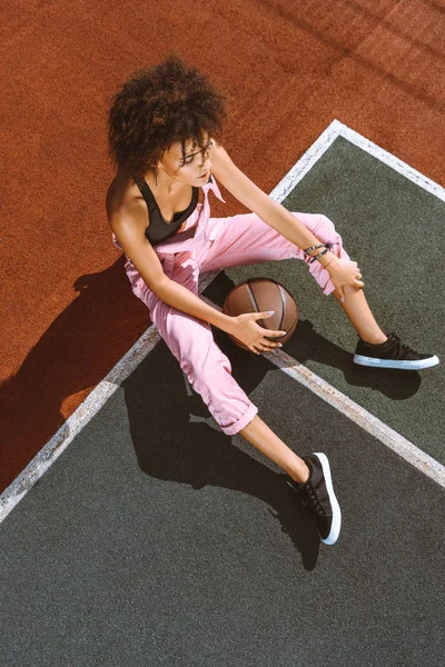Afroamericano en cancha deportiva con baloncesto - foto de stock