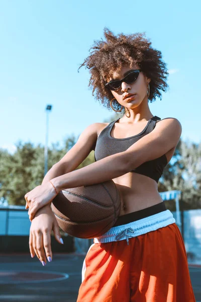 Mujer afroamericana sosteniendo baloncesto - foto de stock