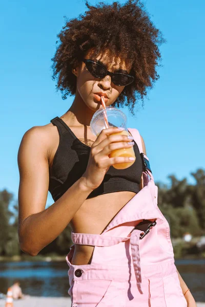 African-american woman drinking juice — Stock Photo