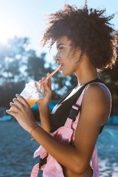 African-american woman drinking juice — Stock Photo