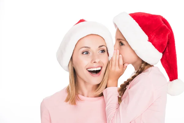 Fille chuchotant à la mère à Noël — Photo de stock