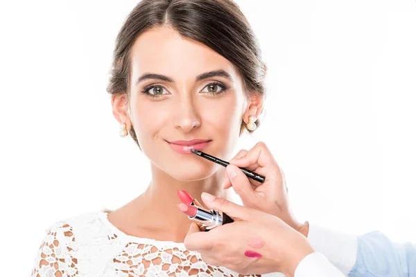 Makeup artist applying lipstick on model — Stock Photo