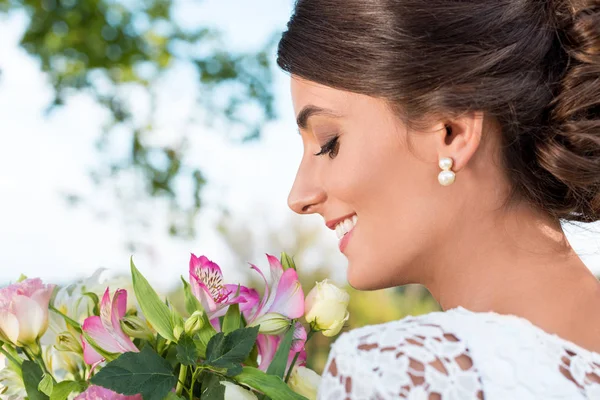 Tender woman with bouquet of flowers — Stock Photo