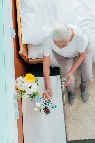 Senior woman taking medicine — Stock Photo