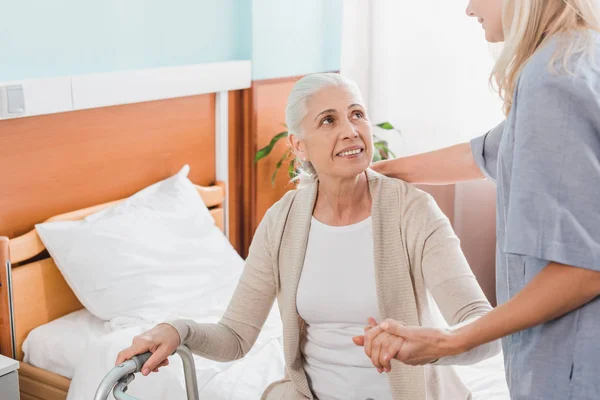 Nurse and senior patient with walker — Stock Photo
