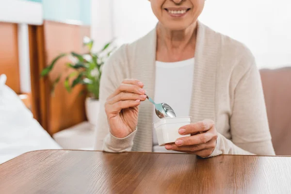 Senior woman eating in hospital — Stock Photo