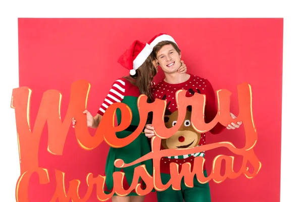 Couple with merry christmas lettering — Stock Photo