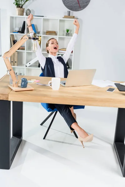 Businesswoman stretching at desk — Stock Photo