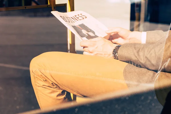 Man with newspaper in bus — Stock Photo