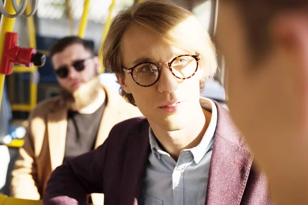 Man in eyeglasses riding in city bus — Stock Photo