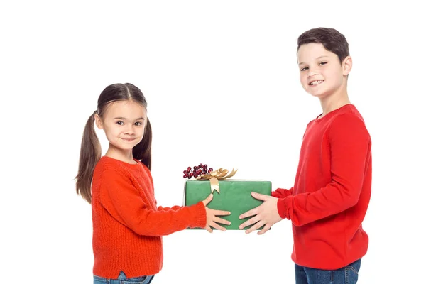 Siblings with christmas gift — Stock Photo