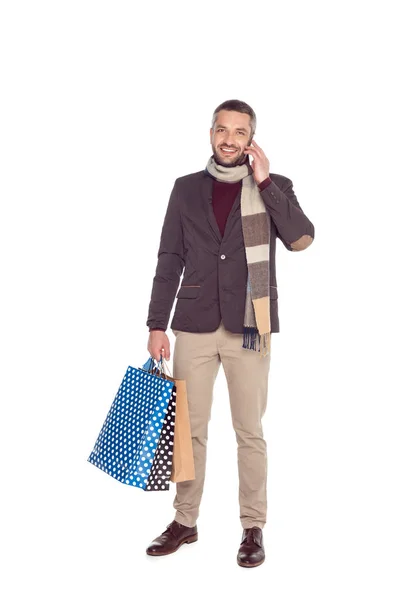 Людина з сумками для покупок і смартфоном — стокове фото